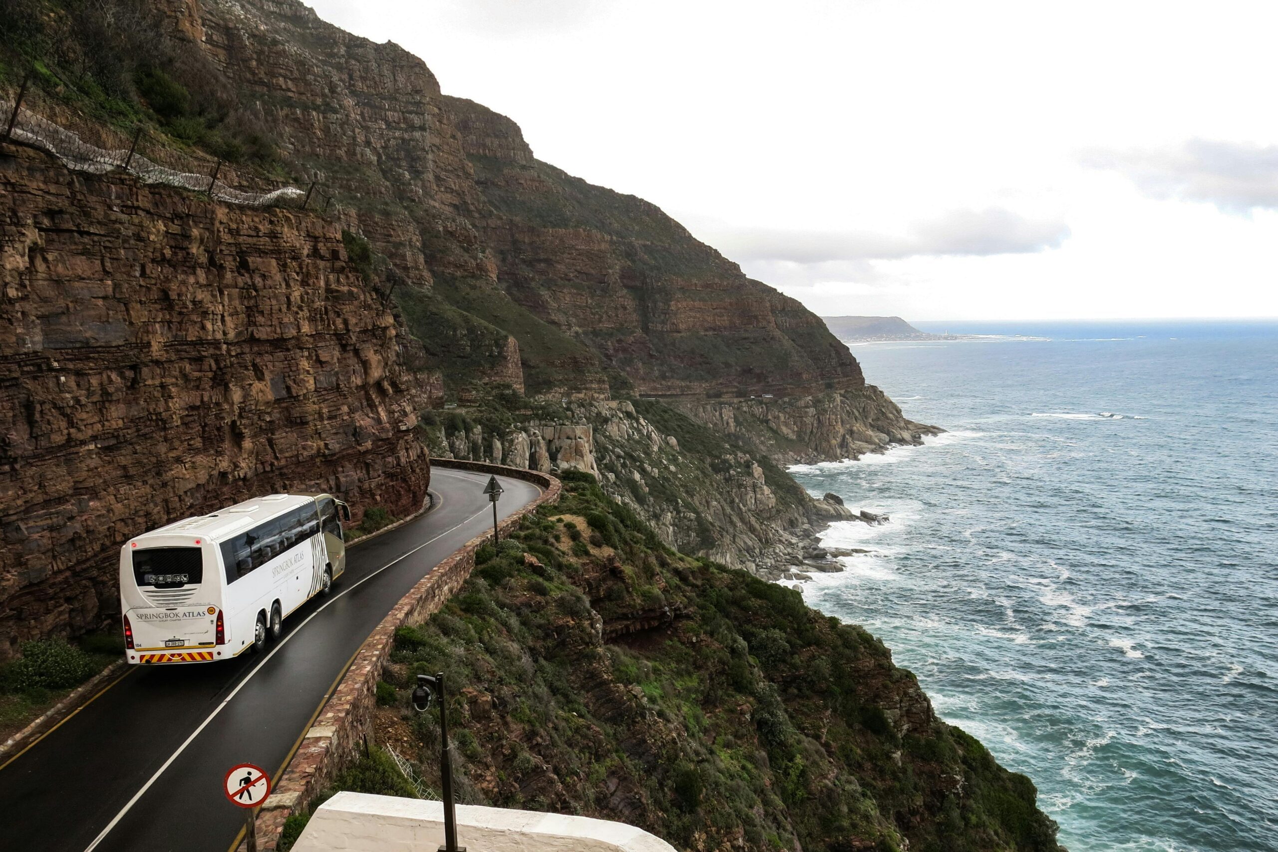 A scenic road trip along dramatic coastal cliffs in South Africa, ideal for travel and adventure.